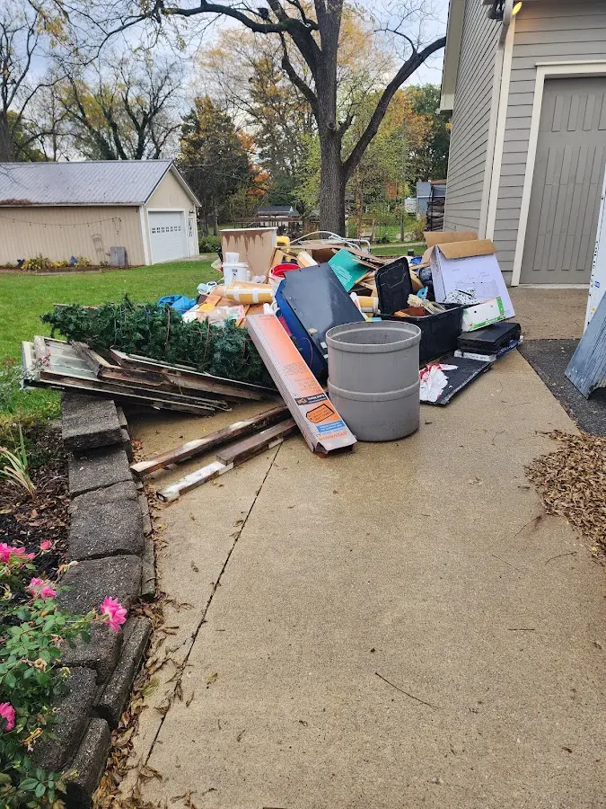 Dumpster being loaded with debris for Commercial Dumpster Rental in Bolton